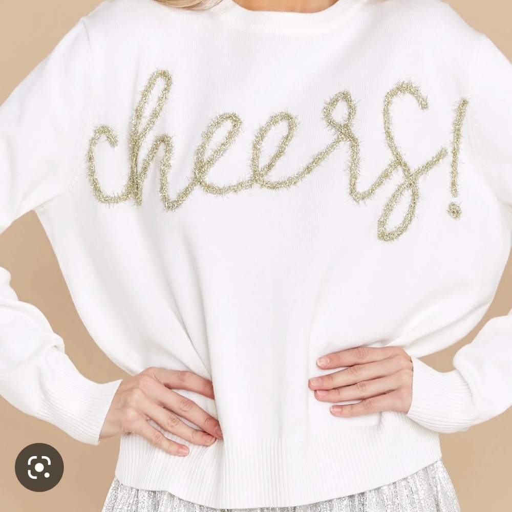 Queen of Sparkles “Cheers” sweater. Never worn, new with tags, size medium.